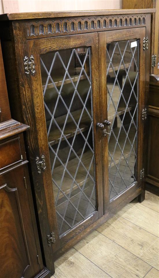 An oak china display cabinet enclosed by a pair of leaded glazed doors, W.92cm